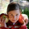 Wolf River Apple -Alpha Young girl with huge Wolf River apples Photo by Jan Mangan